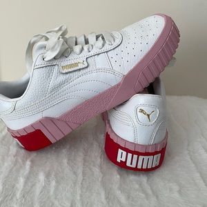 Womens size 5.5  Puma sneakers. Worn only a few times. Leather with pink soles.